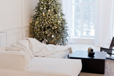 Modern white living room with Christmas tree and light garlandの写真素材