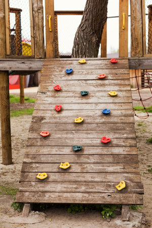 Climbing wall at wooden playground outdoors in the parkの写真素材