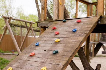 Climbing wall at wooden playground outdoors in the parkの写真素材
