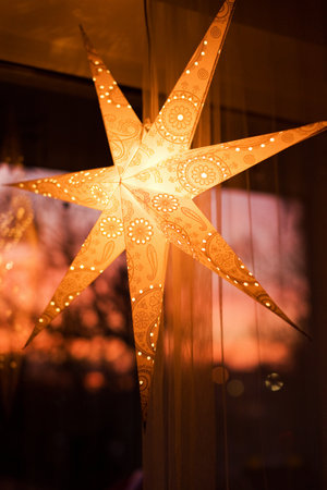 Paper Christmas star hanging on a windowの写真素材