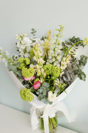 Bouquet with green, white, blue and pink flowersの写真素材