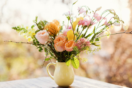 Beautiful bouquet in yellow pitcher vase