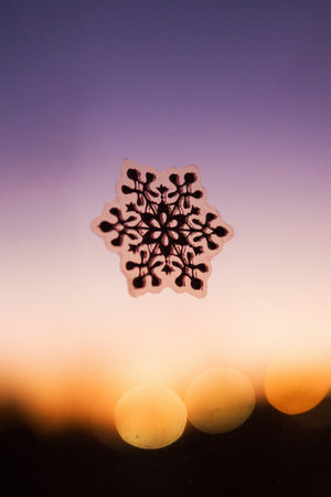 Snowflake sticker with glitter on a windowの写真素材