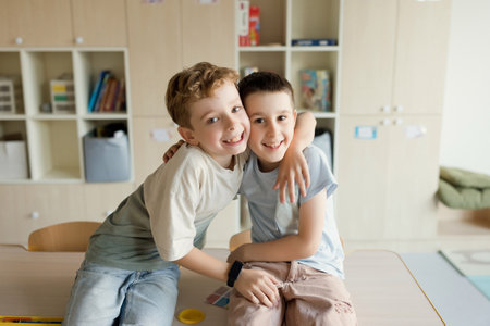 Smiling boys sits in classroom, back to school