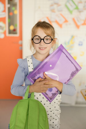 girl in eyeglasses in classroom, back to school