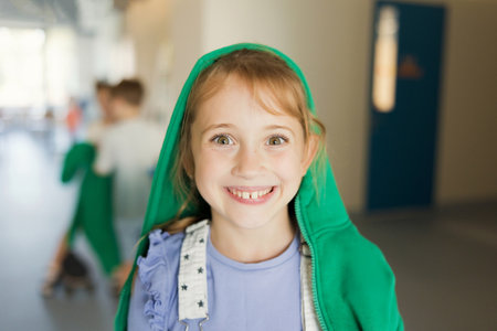Girl in a hood looks at the camera and smilesの写真素材