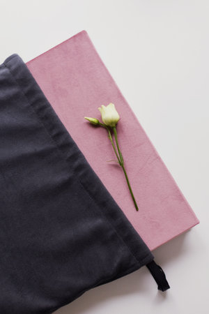 Book in a pink fabric cover and white flower