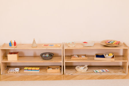 Montessori shelves with educational toys, puzzles, and learning materialsの写真素材
