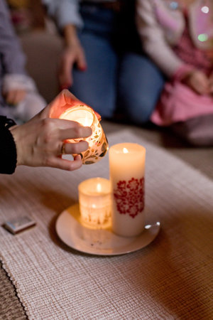 Lighting candles in a cozy, warm, and peaceful gatheringの写真素材