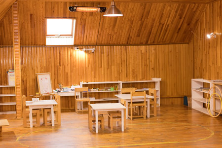 Cozy Montessori classroom with wooden furniture and learning materialsの写真素材