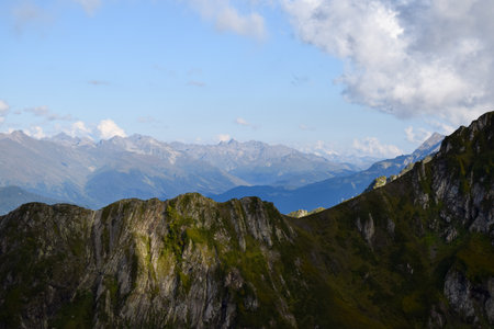 A view of a mountain range with mountains in the background, trending on unsplash, naturalism, creative commons attribution, high dynamic rangeの写真素材