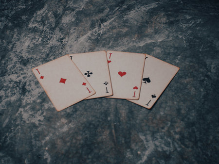 Gloomy photo of playing cards on a marble table. High quality photoの写真素材
