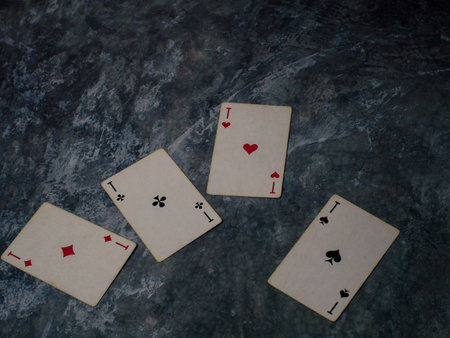 Gloomy photo of playing cards on a marble table. High quality photo