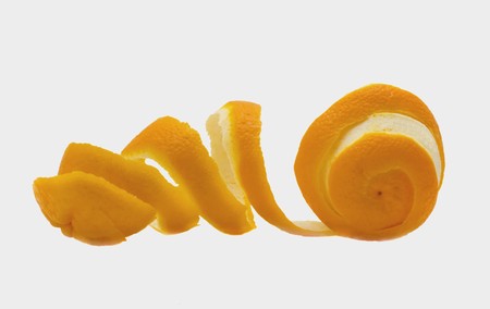 Orange with a peel in the form of a spiral isolated on a white backgroundの写真素材