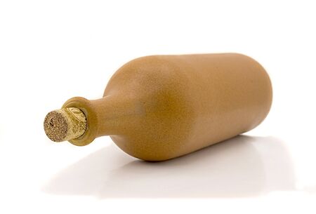 Ceramic bottle of wine lies isolated on a white backgroundの写真素材