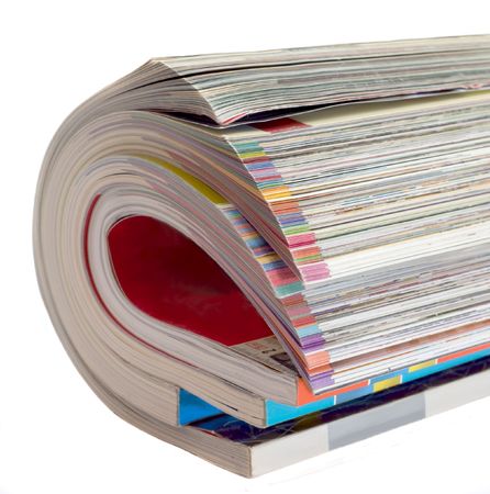Pile glossy magazines is curtailed into roll isolated on white backgroundの写真素材