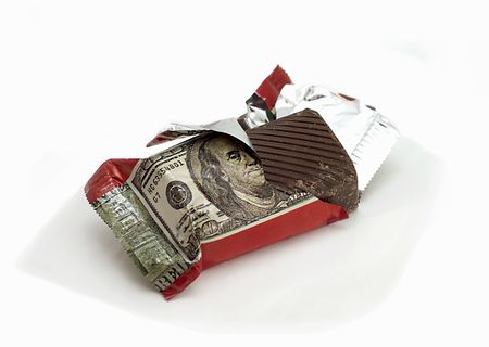 Chocolate with the image of a dollar banknote on a candy wrapperの写真素材