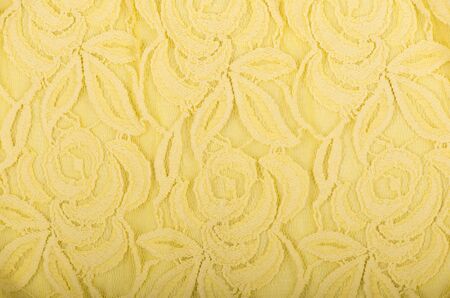 yellow lace texture with floral pattern on white background.