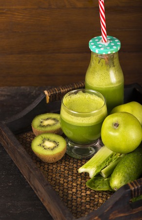 Healthy green smoothie with spinach in a jar mug isolated on whiteの写真素材