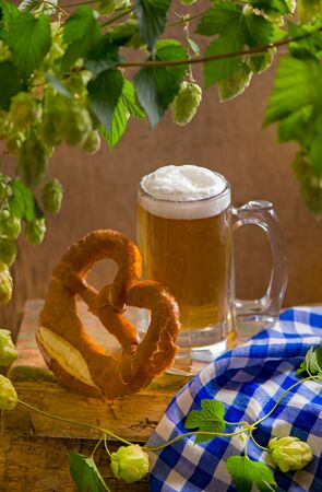 Bavarian Oktoberfest beer and pretzels on wooden tableの写真素材