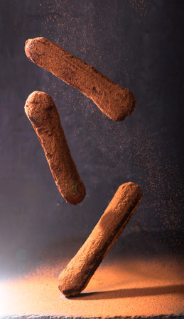 Traditional French dessert. Eclair with chocolate icing. Dark background