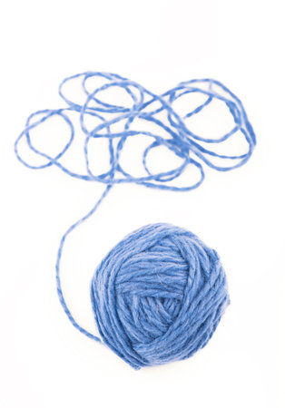 The idea is a tangled thread. Blue ball of yarn on white backgroundの写真素材