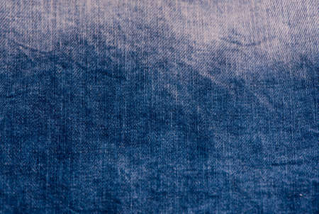 Dark blue denim background, detailed texture with vignette.の写真素材