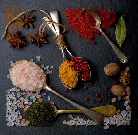 Various spices spoons on table. Top view with copy space