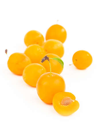Yellow plum with leaves isolated on white background.の写真素材
