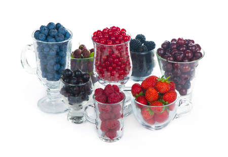 different summer berries red currant, gooseberry, raspberry in glass trays. sorted by type.の写真素材