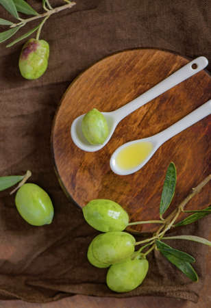 Olive oil and olive branch on the black backgroundの写真素材