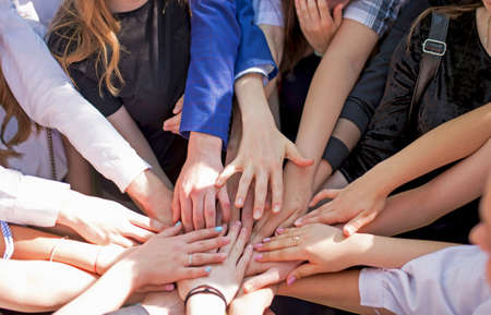Group of children putting their hands together. Concept teamwork partnership.の写真素材