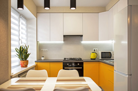 Part of the interior of the living room with a wardrobe and kitchen in orange tonesの写真素材