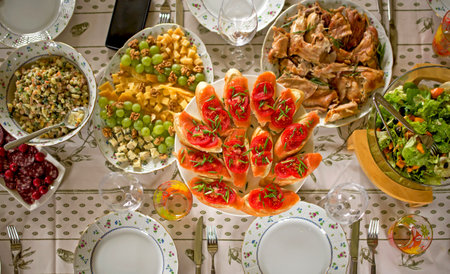 a large and generous table covered with delicious dishes, covered with a tablecloth, on which there...