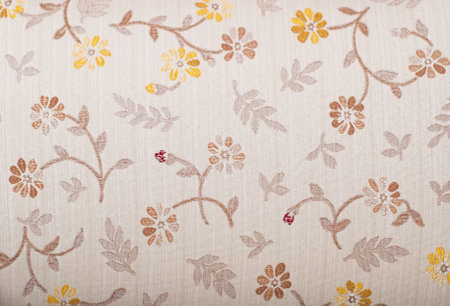 Wooden parquet floor and wallpaper on a wall close up