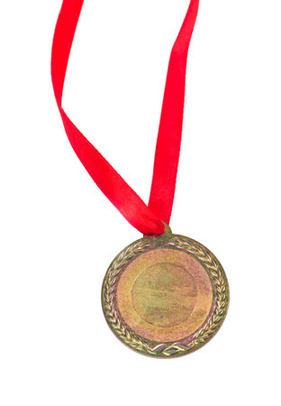Gold medal with a red tape isolated on white.の写真素材