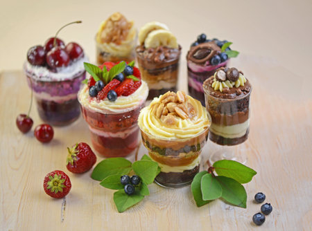 Dessert - red velvet, tiramisu, cheesecake in a glass glass, sweet berry food on the tableの写真素材