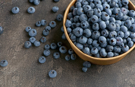 freshly picked blueberries close up with water drops on wood backgroundの写真素材