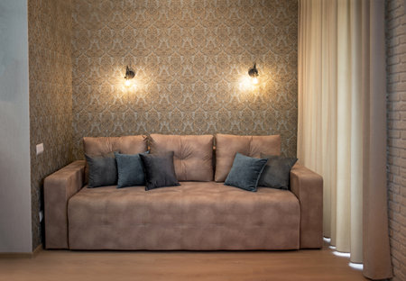 open plan living room and kitchen interior with gray sofa with cushionsの写真素材