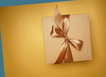 small gift box on yellow background. top view