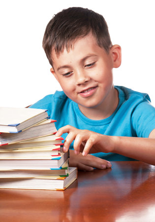 Child and books. The boy reads and plays with books. A preschooler is learning to read. Portrait of...