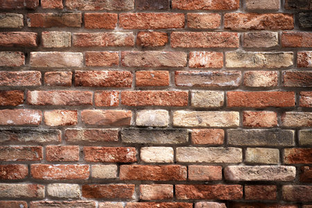 Texture of an old brick wall. Old red brick clay wall with on a sunny day. Clay brick walls of...