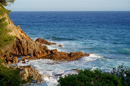 Waves crashing on seashore rocks,Top view sea surface waves background