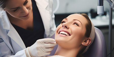 Dentist with gloves checking the teeth of a happy woman in a dental office. focus on patient care and comfort. A.I.の素材