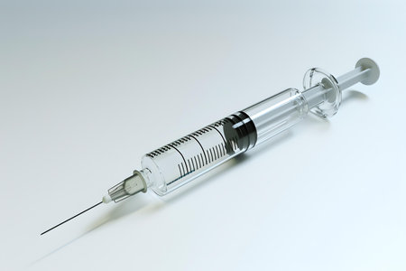 A clear glass syringe against a white backdrop, highlighting its sterile and precise nature for medical use. A.I.の素材