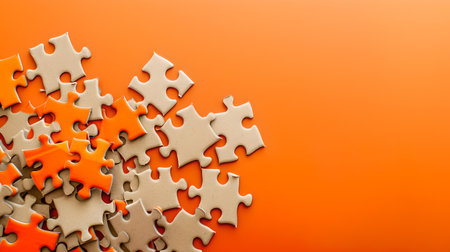 An array of unfinished white jigsaw puzzle pieces casually spread over an orange surface shows complexity and problem-solving. A.I.の素材
