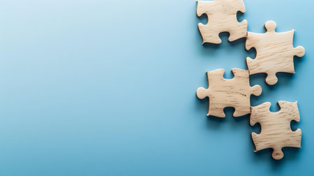 Wooden puzzle pieces scattered on a solid blue backdrop, representing teamwork, challenge, and strategy. A.I.の素材