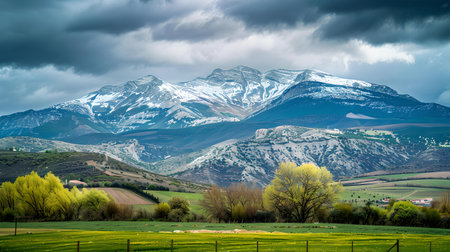 A scenic landscape encapsulating the beauty of nature with snow-capped mountains and stormy skies. A.I.の素材