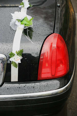 Black wedding limousine decorated by tapesの写真素材