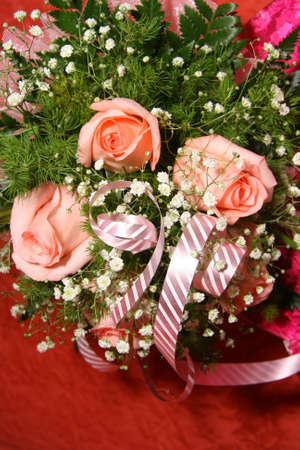 Beautiful bouquet of roses on a red backgroundの写真素材